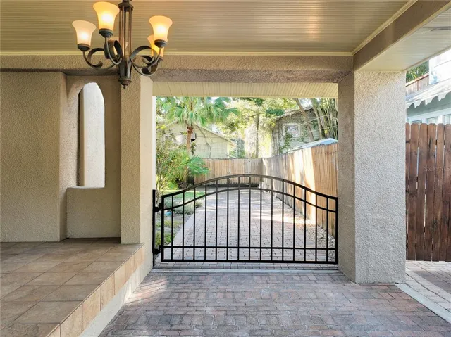 a view of an empty room with wooden floor fireplace and a window