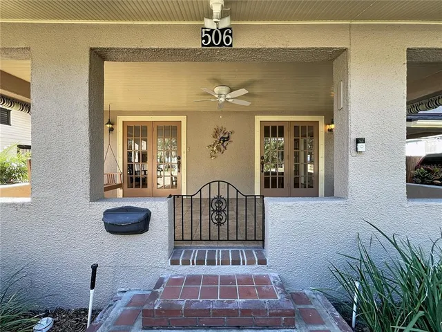 an empty room with fireplace wooden floor and windows