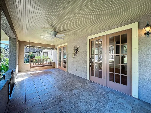 a view of an empty room with wooden floor and a fireplace