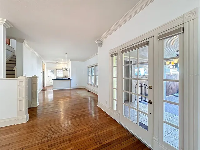 a view of a hallway with wooden floor and staircase