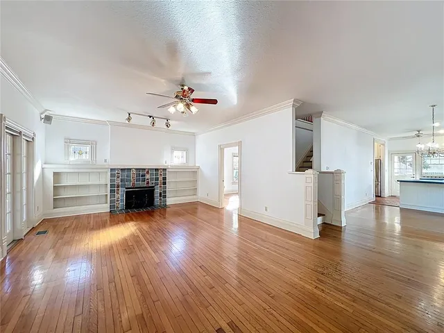 a view of a room with wooden floor and window