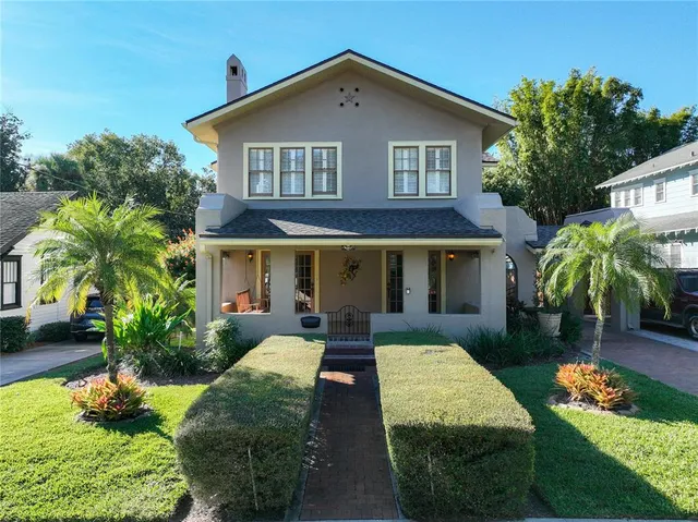 a front view of a house with garden and porch