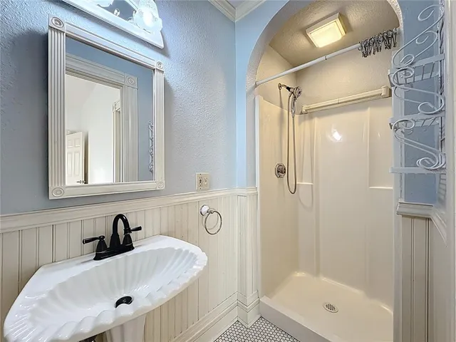 a kitchen with granite countertop white cabinets white appliances with a sink and dishwasher with wooden floor
