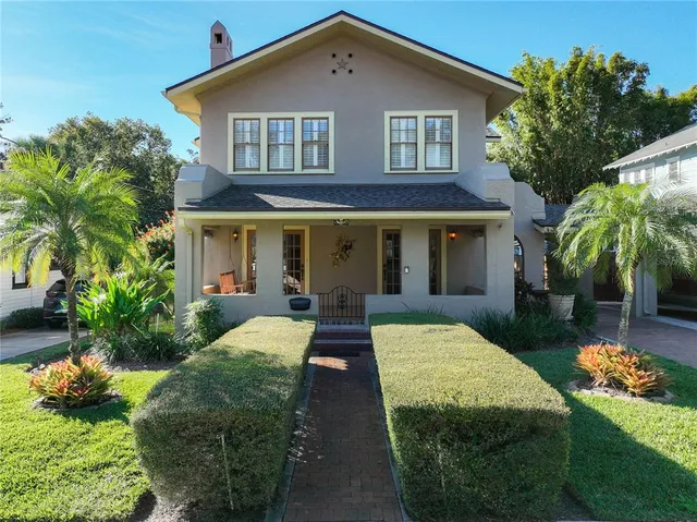 a front view of houses with yard