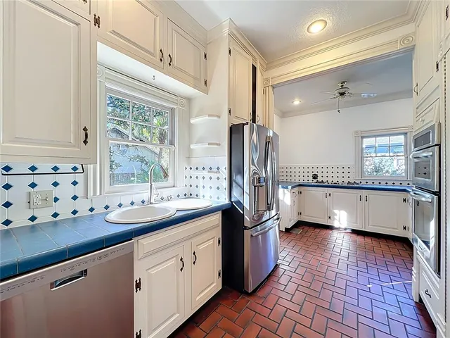 a living room with a ceiling fan and a window