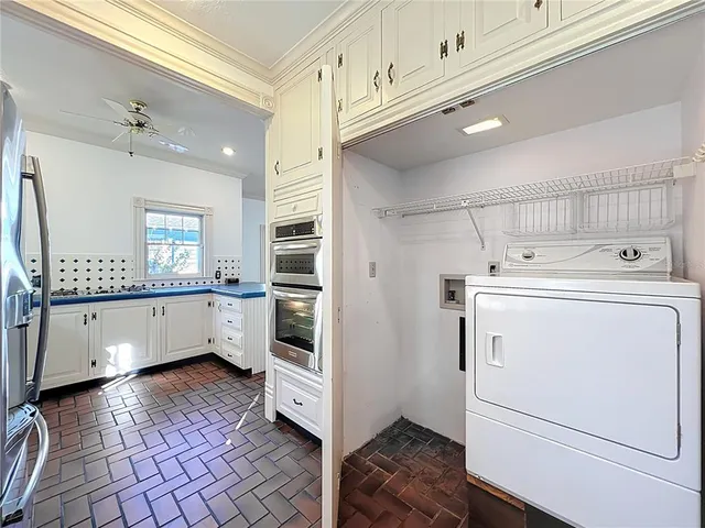 a view of a house with a small yard and floor to ceiling window