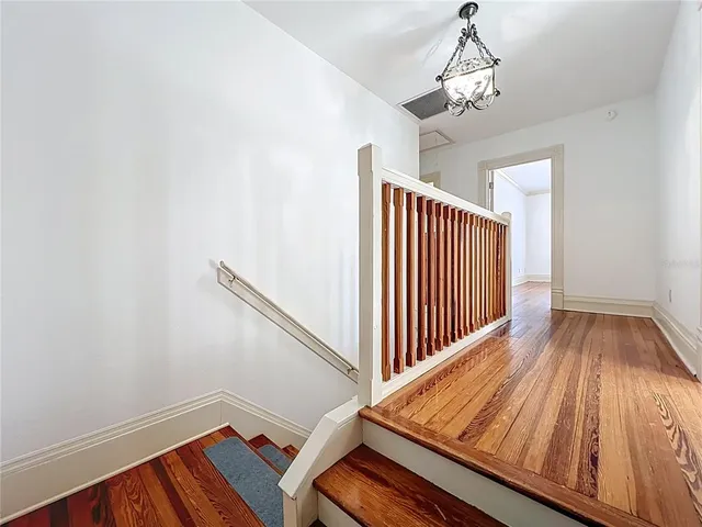 an aerial view of a house with a yard potted plants and large tree