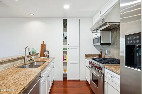 a view of a kitchen with a sink and a stove top oven