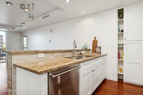a kitchen that has a sink and a stove