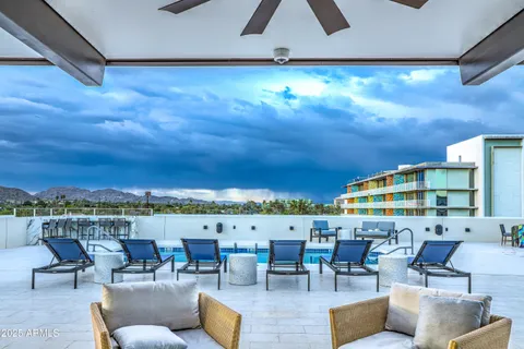 an outdoor living with furniture and garden view