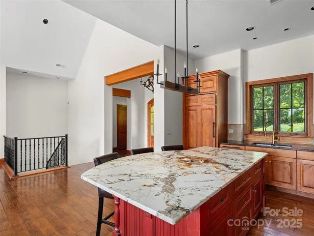a kitchen view with granite countertop a stove a sink dishwasher and a refrigerator with wooden floor