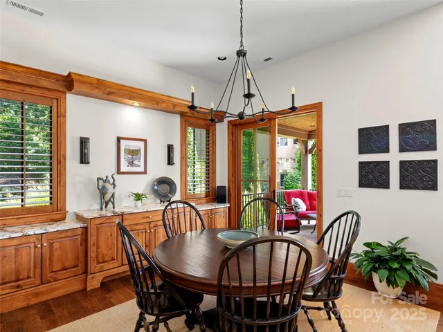 a view of a dining room and livingroom with furniture window and wooden floor