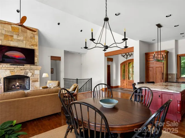 a view of a dining room with furniture and a chandelier