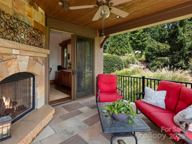 a outdoor living space with furniture and a fireplace