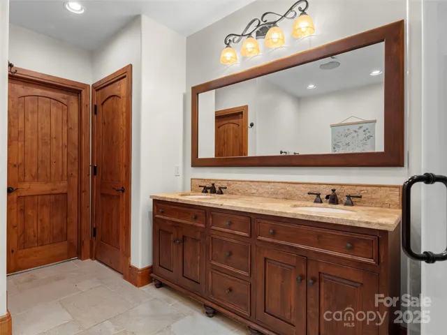 a bathroom with a double vanity sink and a mirror