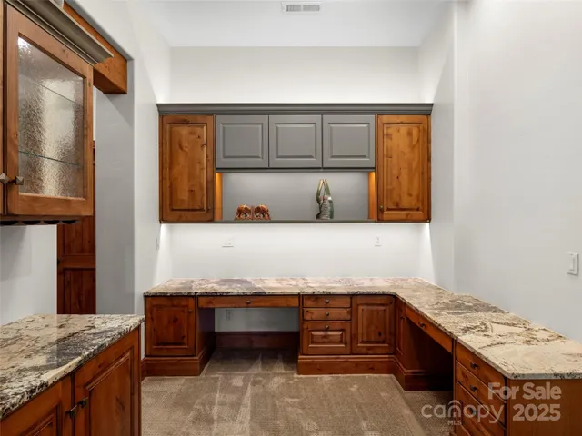 a kitchen with granite countertop a sink and a stove