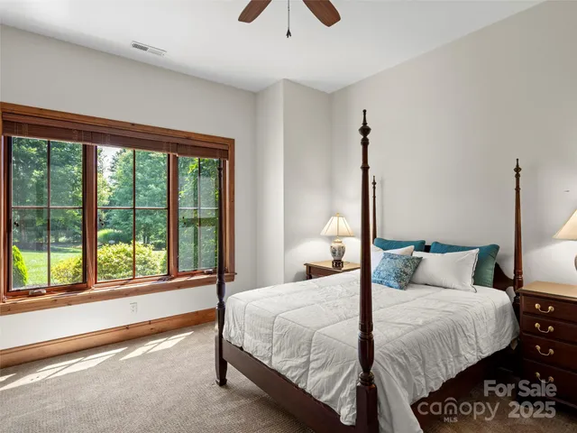 a bedroom with a large bed and a large window