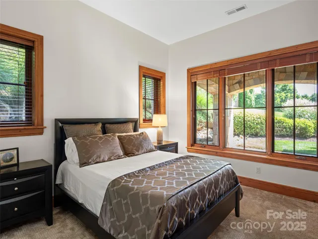 a bedroom with a bed and a large window