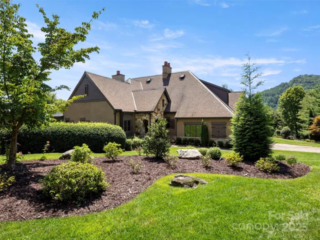 a aerial view of a house with swimming pool garden and patio
