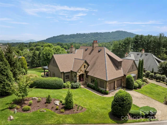 a aerial view of a house with a yard