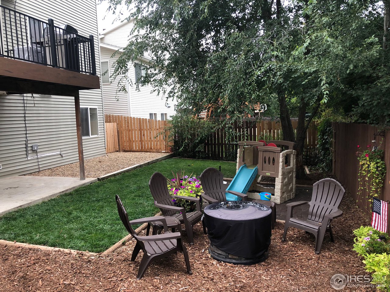 1282 Trail Ridge Road Longmont, CO 80504 - Photo 16 of 31 a view of a chair and table in backyard of the house