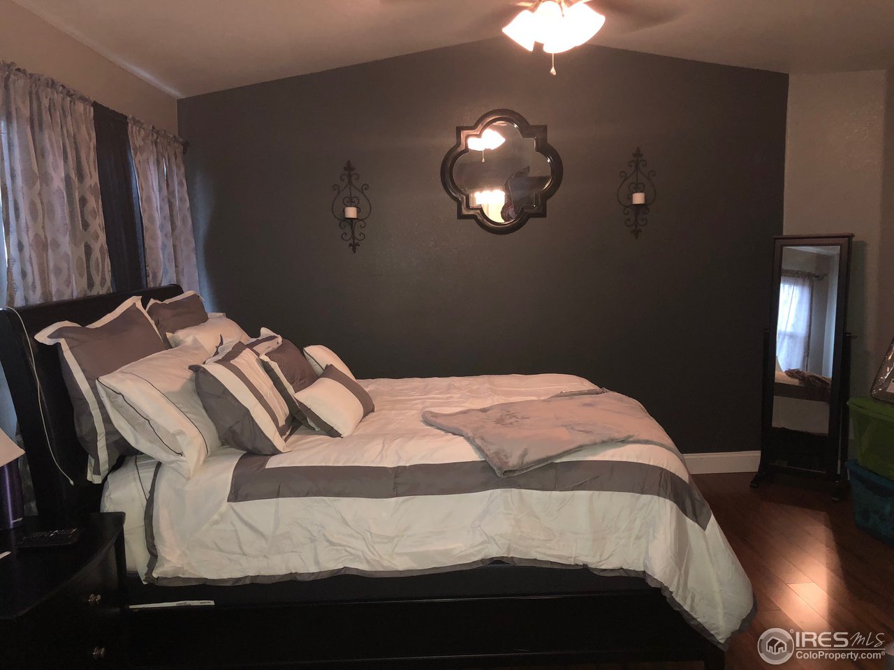 1282 Trail Ridge Road Longmont, CO 80504 - Photo 20 of 31 a bedroom with a bed and wooden floor