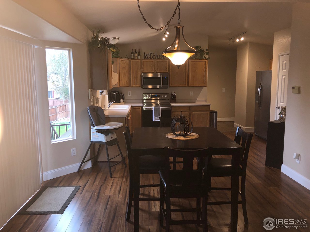 1282 Trail Ridge Road Longmont, CO 80504 - Photo 8 of 31 a view of a dining room with furniture and wooden floor