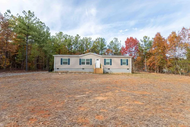 a front view of house with yard and trees