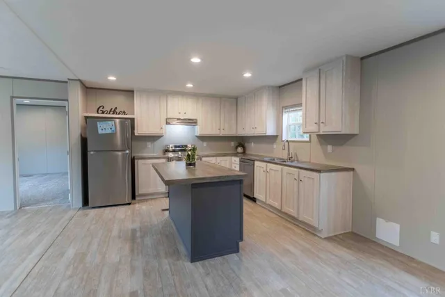 a kitchen with stainless steel appliances granite countertop a refrigerator sink and cabinets