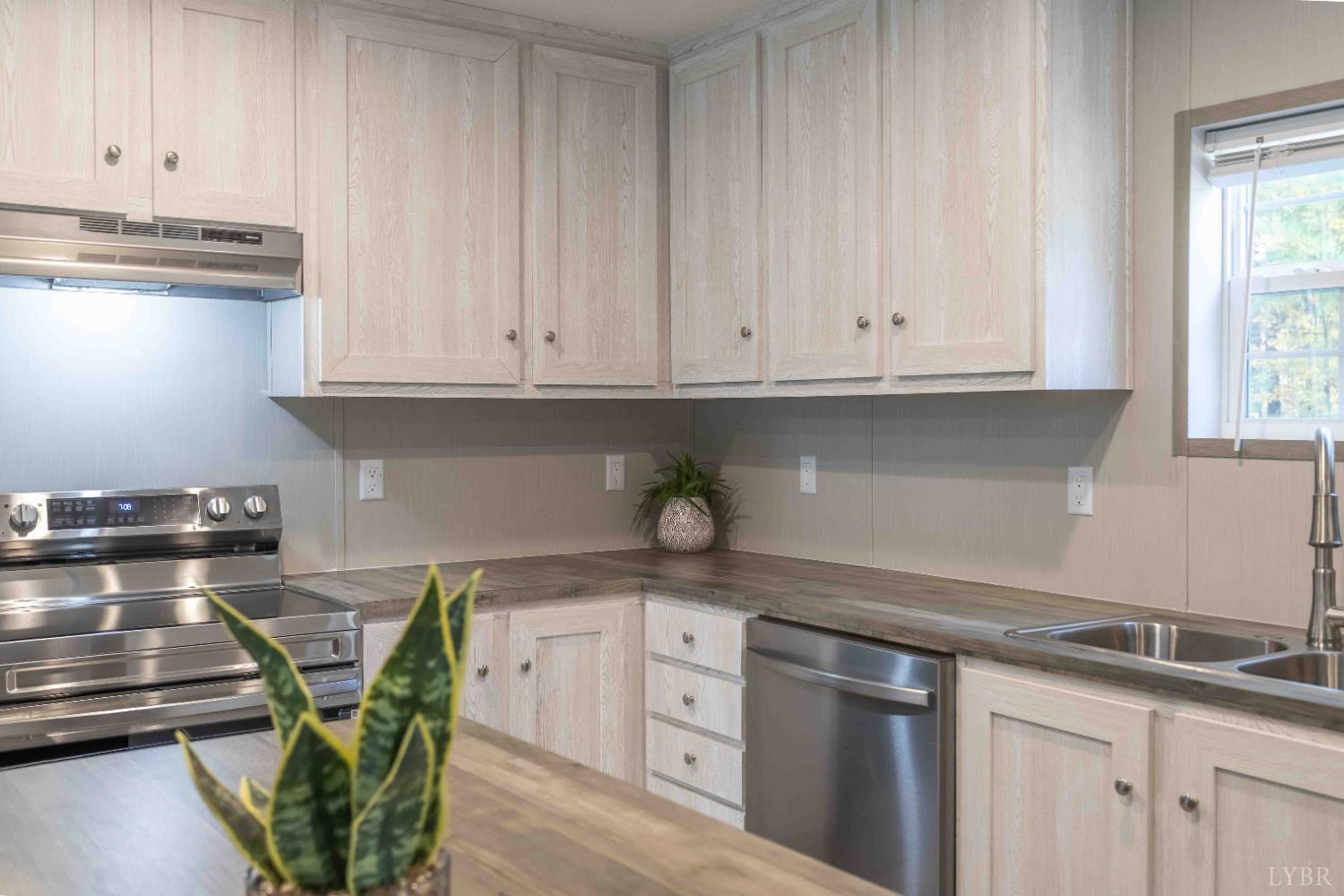 1007 Austin Road Gladstone, VA 24553 - Photo 13 of 35 a kitchen with stainless steel appliances granite countertop a sink a stove and white cabinets
