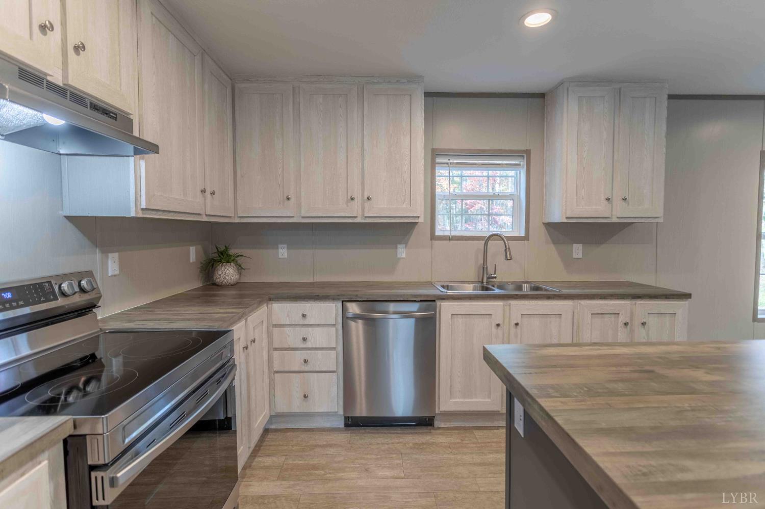 1007 Austin Road Gladstone, VA 24553 - Photo 16 of 35 a kitchen with stainless steel appliances granite countertop a stove a sink and a granite counter tops