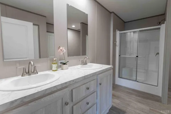 a bathroom with double vanity sinks and a mirror