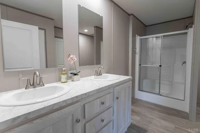 a bathroom with double vanity sinks and a mirror