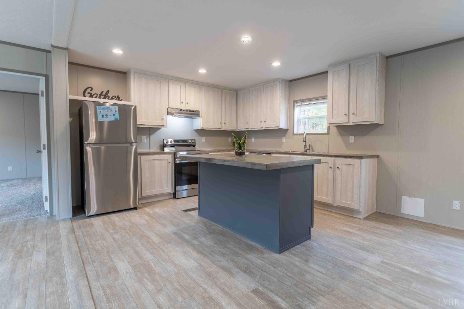 1007 Austin Road Gladstone, VA 24553 - Photo 3 of 35 a kitchen with stainless steel appliances granite countertop a stove a sink a refrigerator and white cabinets with wooden floor