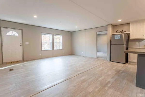 a view of empty room with wooden floor and windows