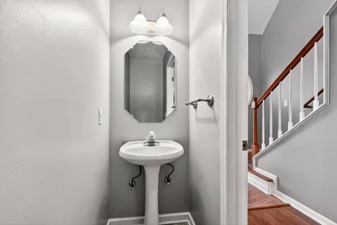 a bathroom with a sink a mirror and shower