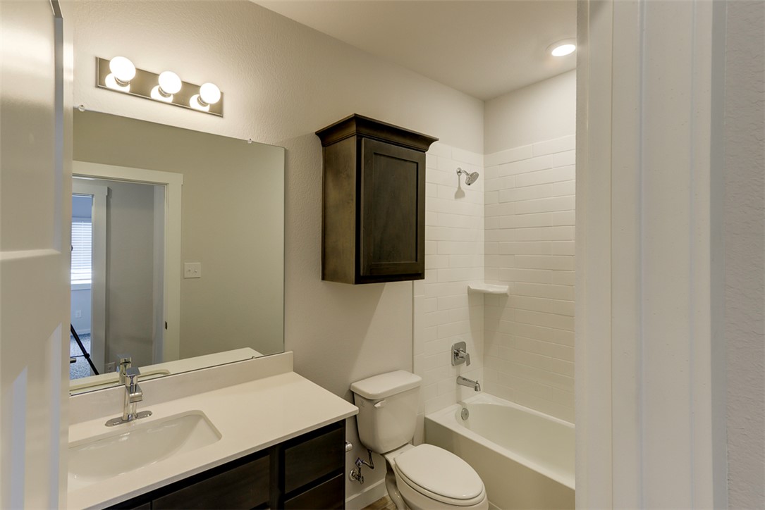 760 Double Mountain Road College Station, TX 77845 - Photo 22 of 26 a bathroom with a toilet a sink and mirror
