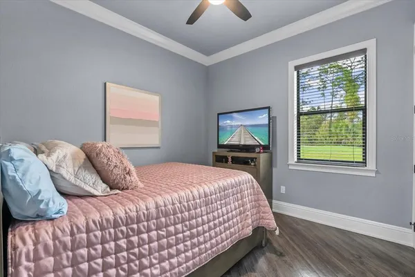 a bedroom with a bed and a chandelier