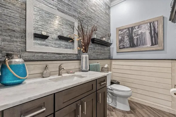a bathroom with a toilet sink and mirror