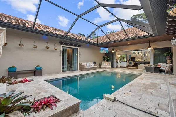 a view of swimming pool with outdoor seating
