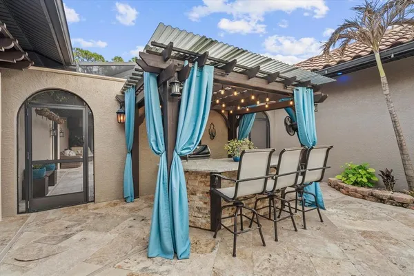 a view of a chairs and table in the patio