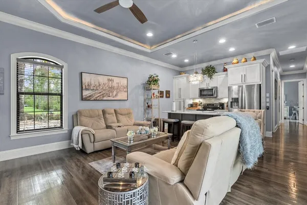 a living room with furniture window and wooden floor
