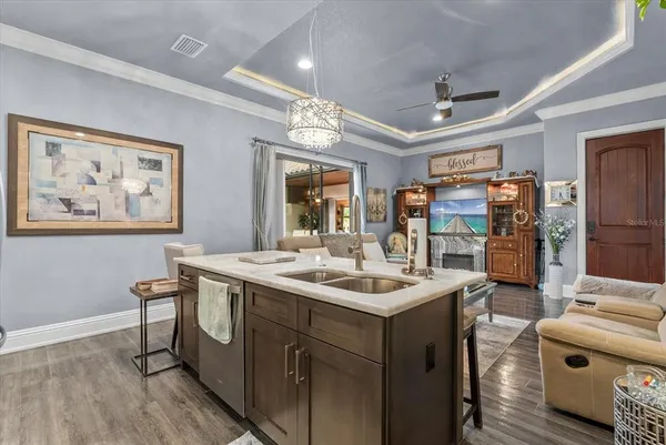 a view of a kitchen with stainless steel appliances granite countertop a sink and a stove with wooden floor
