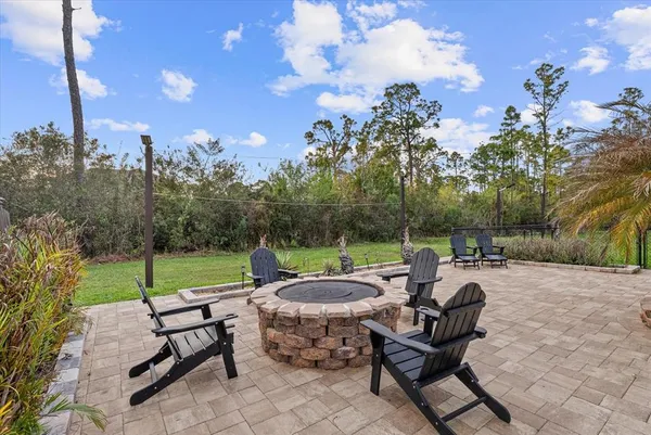 a view of a yard with furniture and a fire pit