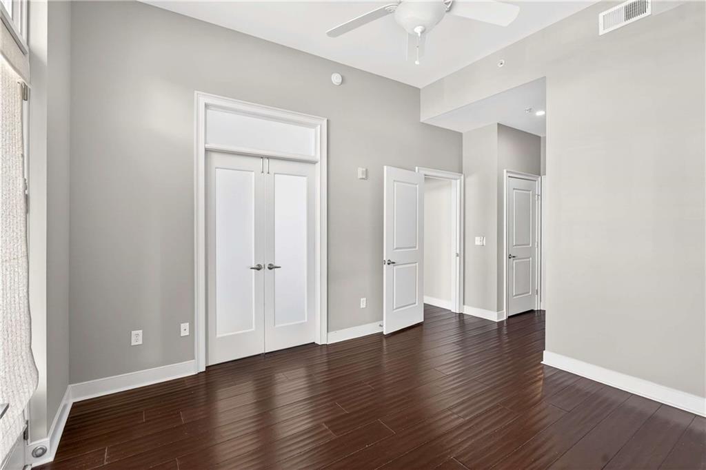 201 West Ponce De Leon Avenue, Unit 702 Decatur, GA 30030 - Photo 13 of 41 an empty room with wooden floor and closet