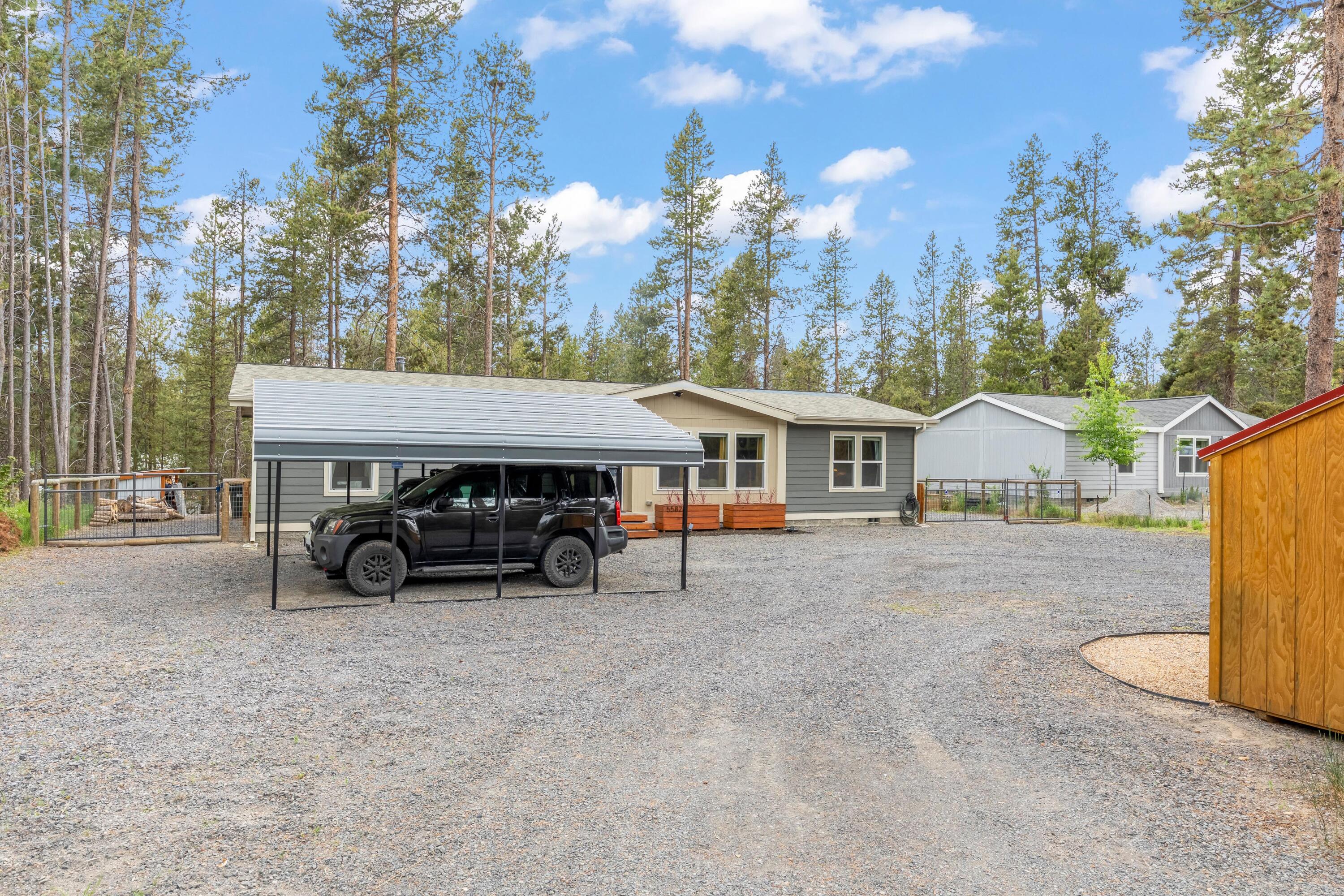 55823 Snow Goose Road Bend, OR 97707 - Photo 31 of 36 a view of house with outdoor seating and covered with trees in the background