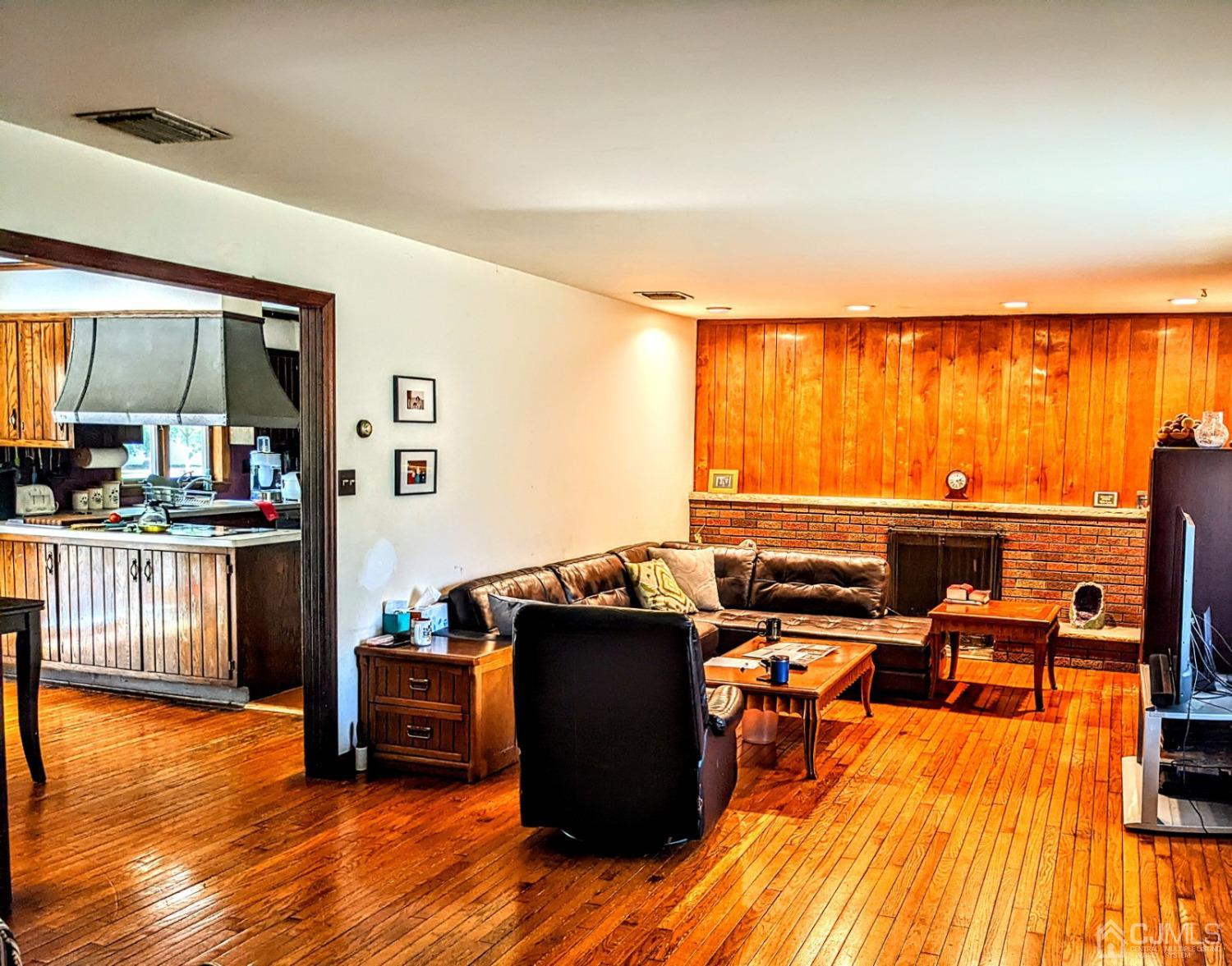 25 Parker Road Edison, NJ 08820 - Photo 4 of 9 a view of a living room and kitchen floor to ceiling window and wooden floor