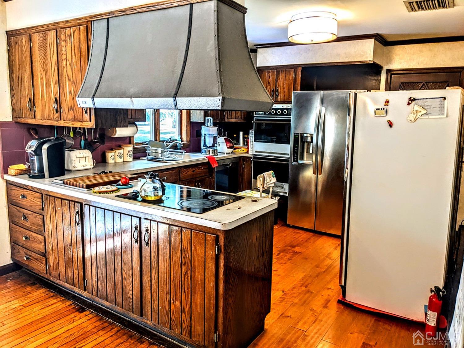 25 Parker Road Edison, NJ 08820 - Photo 5 of 9 a kitchen with stainless steel appliances granite countertop a refrigerator a sink and a stove