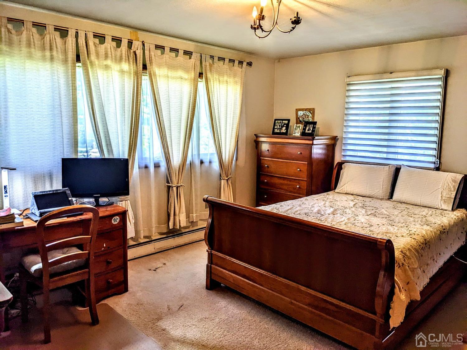 25 Parker Road Edison, NJ 08820 - Photo 8 of 9 a bedroom with a bed and a television