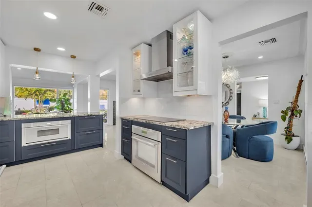 a kitchen with a sink and a stove top oven